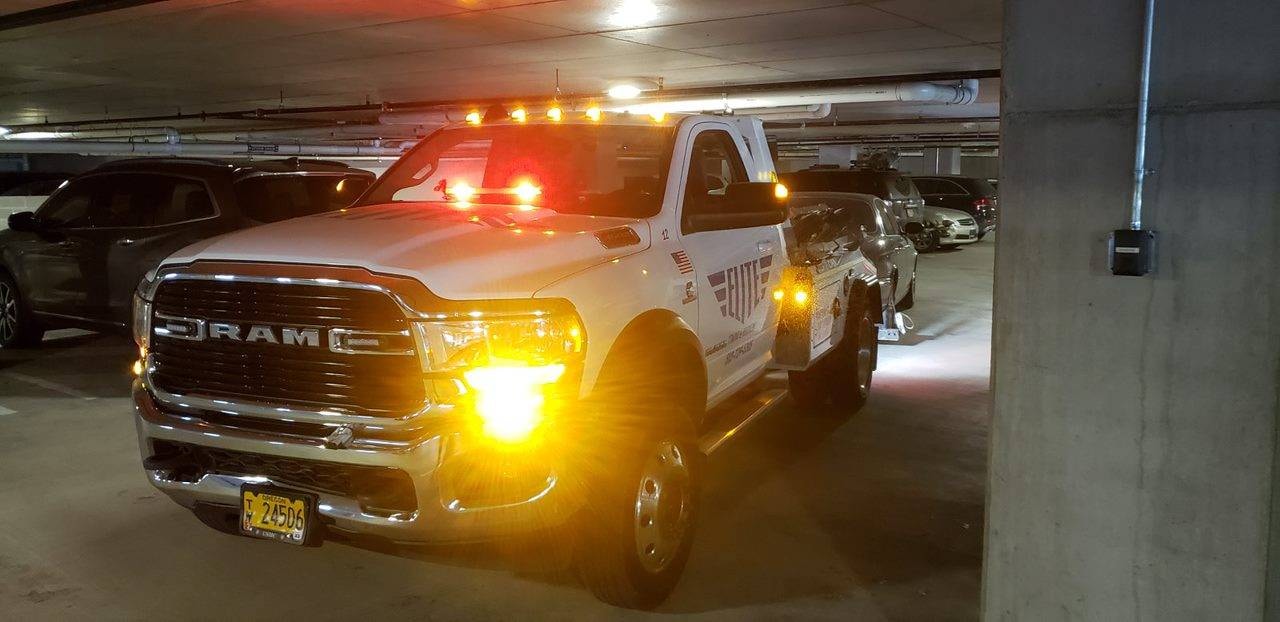 Elite Towing & Recovery truck in a parking garage at night
