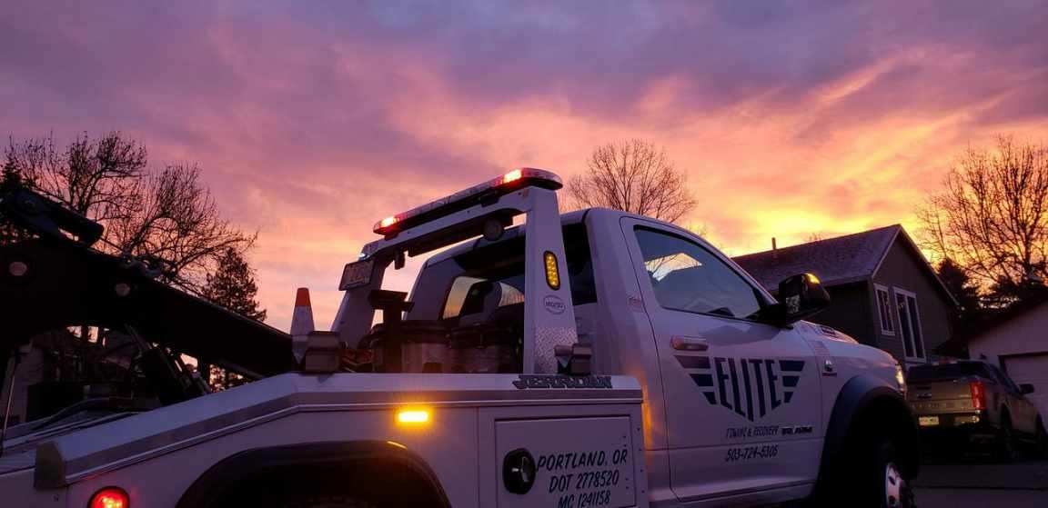 Elite Towing & Recovery truck at sunset